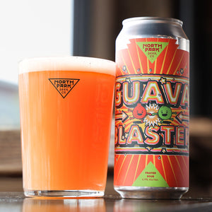 Can of Guava Blaster Fruited Sour next to glass of beer