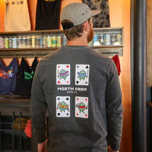Someone wearing a long sleeve tshirt with Disciples of Fu! characters featured as a set of House of Fu! playing cards t-shirt on the back.
