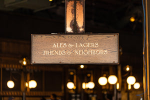 Ales and Lagers, Friends and Neighbors Sign above entryway door at NPBC