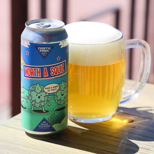 Can of NPBC Worth a Squiz next to  a glass of beer