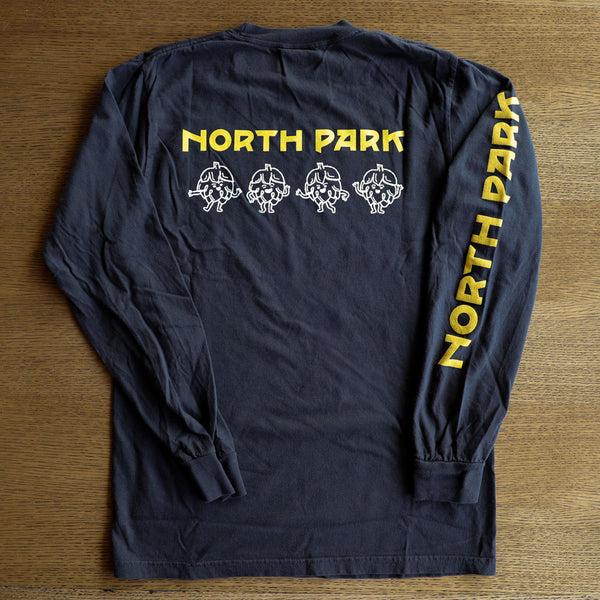 Black long-sleeve shirt with 'North Park' text and graphics on a wooden surface