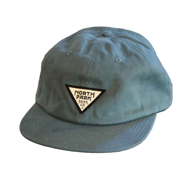 Teal cap with a triangle logo patch on a white background