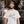 Load image into Gallery viewer, A smiling man stands in a brewery wearing a cream-colored t-shirt featuring a crossword puzzle graphic spelling out ' NORTH PARK BEER CO and SD'.
