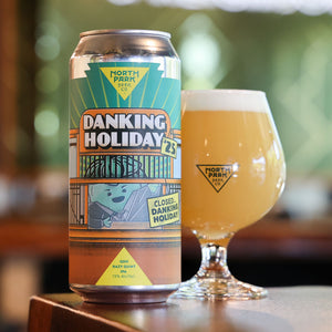 Can and glass of North Park Beer Co. Danking Holiday beer on a blurred background