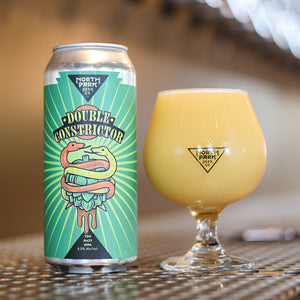 photo of can of Double Constrictor TDH Hazy DIPA beside a glass of beer