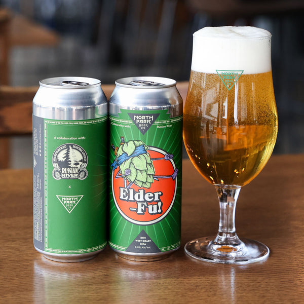 Two cans of 'Elder Fu!' DDH West Coast DIPA and a glass of beer on a wooden table.