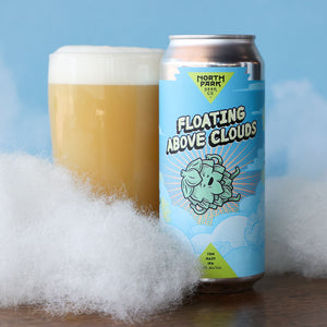 North Park Beer Co Floating Above Clouds Hazy IPA next to a glass of beer