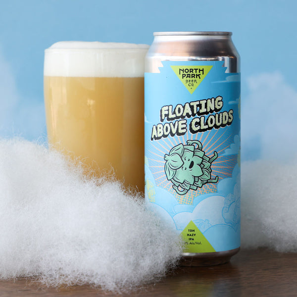 North Park Beer Co Floating Above Clouds Hazy IPA next to a glass of beer