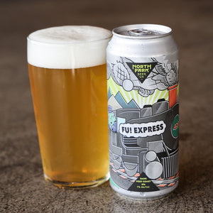 Beer can labeled 'Fu! Express' next to a glass of beer on a textured surface.