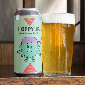 Can of 'Hoppy Jr.' beer with a glass of beer on a wooden surface