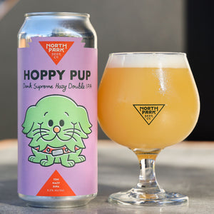 Can of Hoppy Pup Dank Supreme Hazy DIPA next to glass of beer