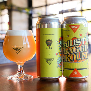 Two cans of Just Claggin' Around TDH Hazy TIPA next to glass of beer