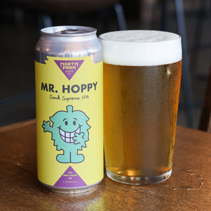 Can of North Park Beer Mr. Hoppy and a glass of beer on a wooden table.