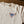 Load image into Gallery viewer, NPBC triangle logo in navy, light blue and orange on the front pocket area of tshirt laying on a table.
