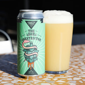 North Park Beer Co. TDH Aroma Constrictor can next to glass of beer