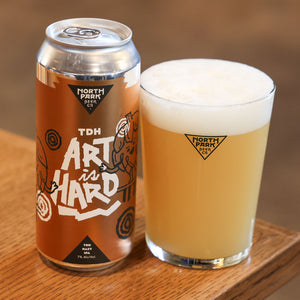 Can of TDH Art is Hard: Gold Label TDH Hazy IPA next to glass of beer