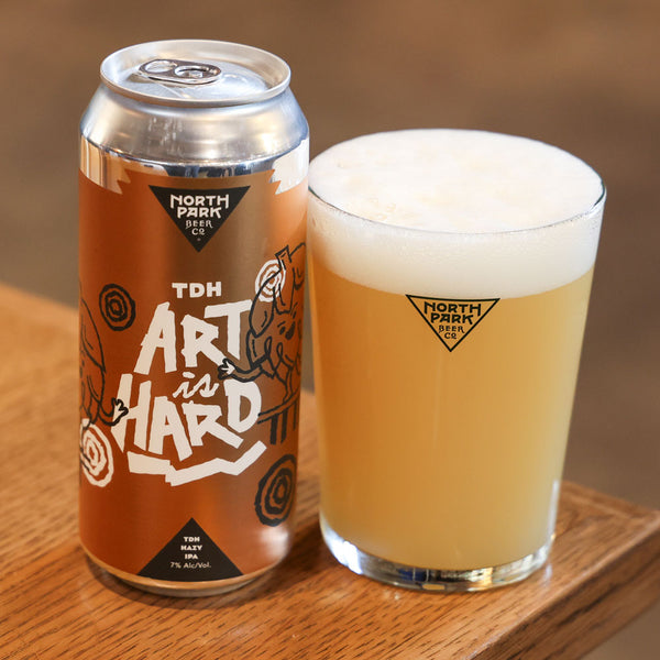 Can of TDH Art is Hard: Gold Label TDH Hazy IPA next to glass of beer