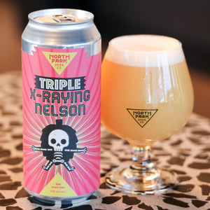 Can of Triple X-Raying Nelson TDH Hazy TIPA next to glass of beer