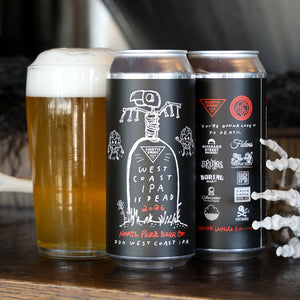 Two black West Coast IPA beer cans with white and red gothic illustrations are displayed on a wooden surface next to a glass of foamy golden beer. Skeleton hands are visible on the right side.