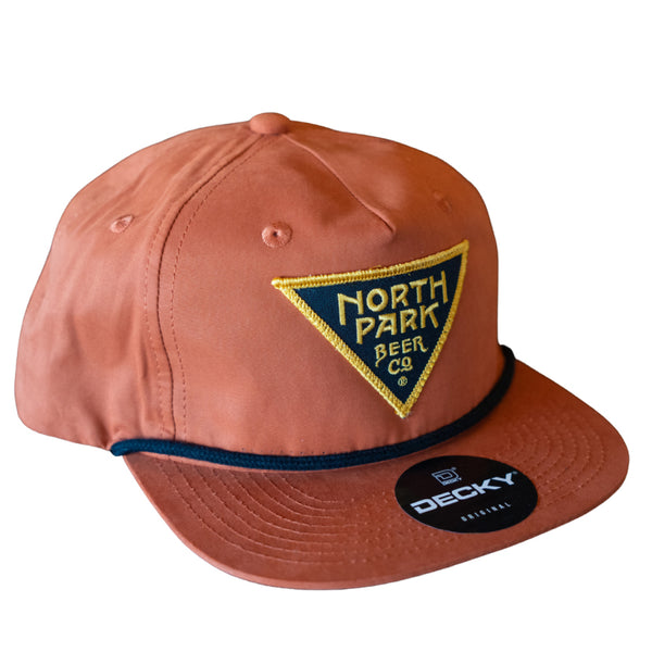 Rust Orange Cotton/Poly 5 panel hat with a triangle logo patch on the front and a rope detail across the bill.