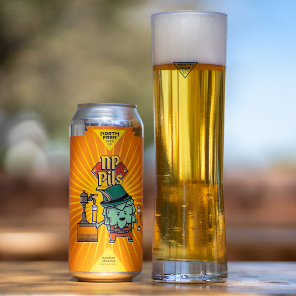 photo of NP Pils Bavarian Style Pils can beside a glass of beer